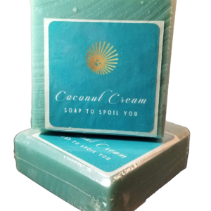 Two Clean Mint Soap Bars sit against a bright white background. They are a fresh pale green color and sport a turquoise blue label with Coconut Cream Soap's logo of a smiling sun along with the words Coconut Cream Soap to Spoil You.
