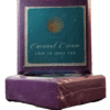Two Mountainside Forest Soap Bars are set against a bright white background. They are royal purple in color and sport a turquoise blue label with Coconut Cream Soap's logo of a smiling yellow sun and the words Coconut Cream Soap to Spoil You.