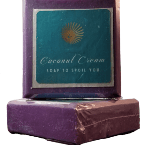 Two Mountainside Forest Soap Bars are set against a bright white background. They are royal purple in color and sport a turquoise blue label with Coconut Cream Soap's logo of a smiling yellow sun and the words Coconut Cream Soap to Spoil You.